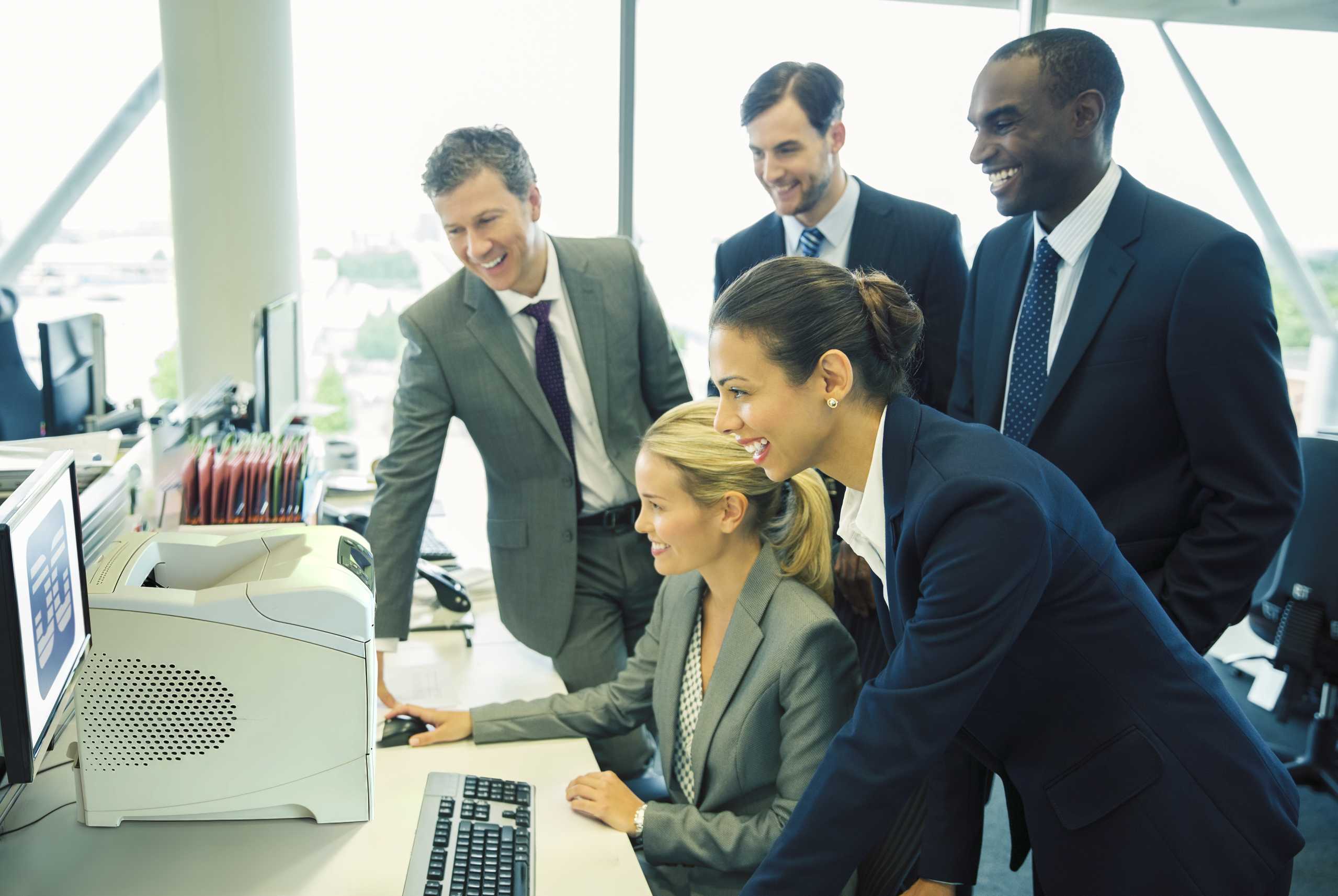 Business team gathered around a Data Growth printer
